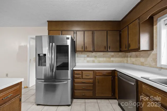 a kitchen with a refrigerator and a sink