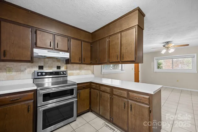 a kitchen with a sink stove and cabinets