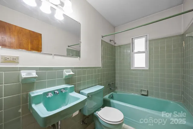 a bathroom with a sink mirror toilet and bathtub
