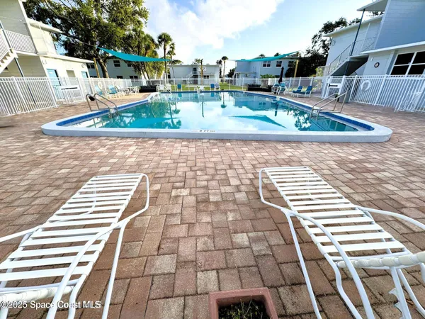 a view of a swimming pool with a yard