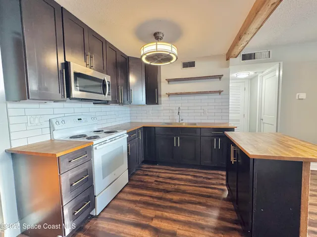 a refrigerator freezer sitting inside of a kitchen