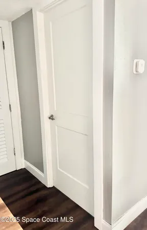 a living room with stainless steel appliances kitchen island granite countertop a stove top oven a sink and a wooden floors