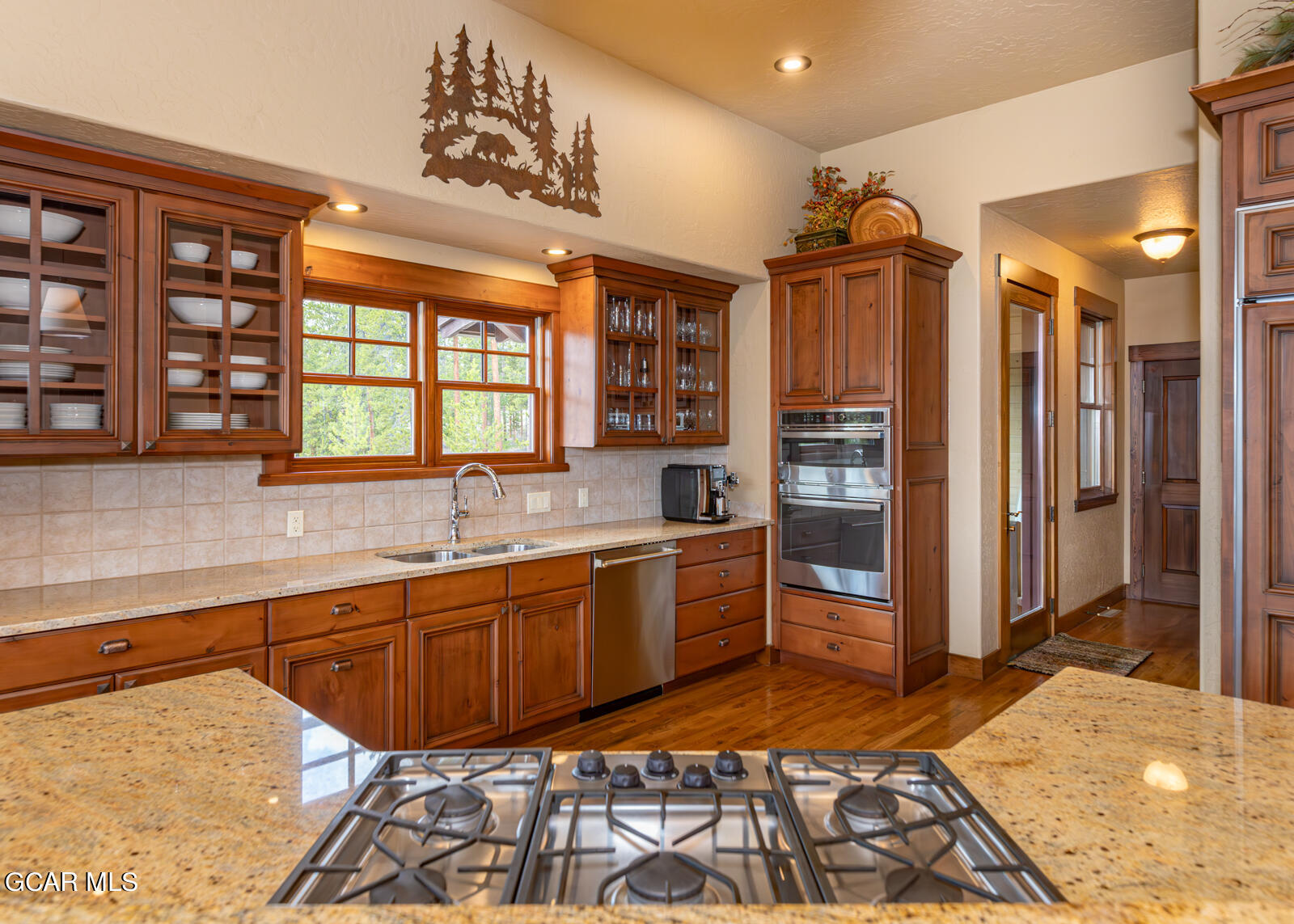 40 Golf Course Circle Tabernash, CO 80478 - Photo 17 of 57 a large kitchen with kitchen island granite countertop a large window and stainless steel appliances
