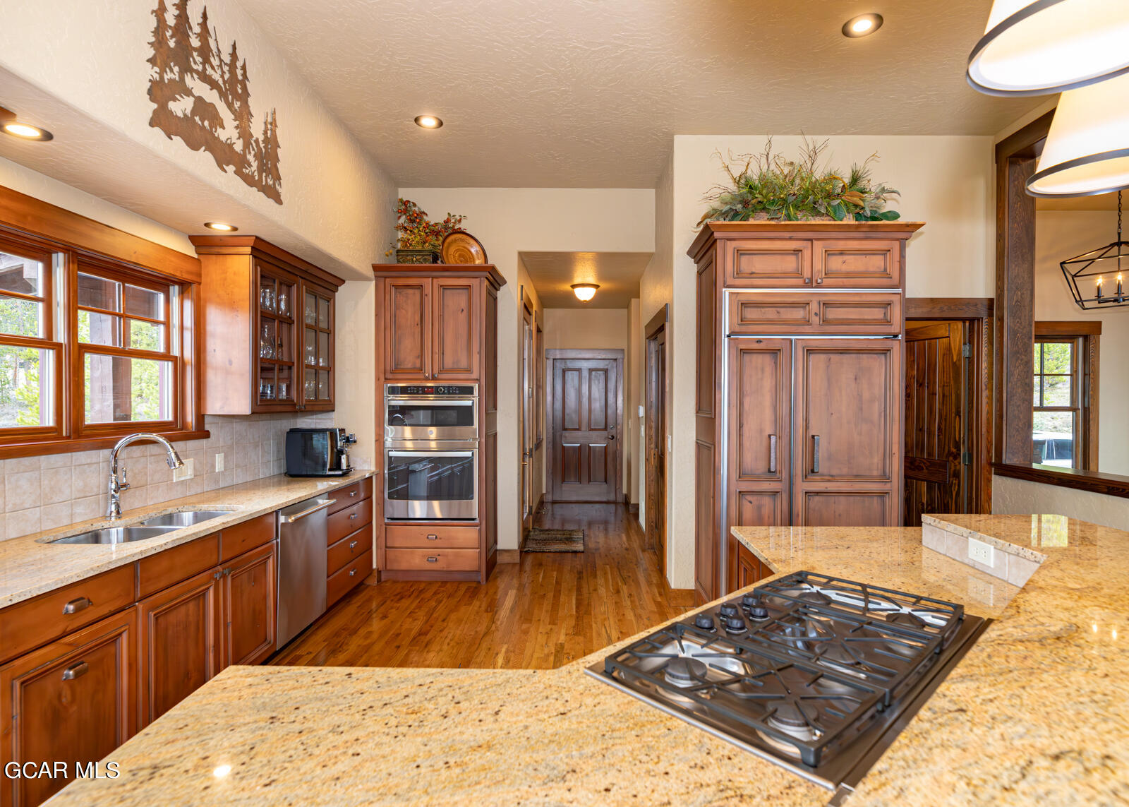 40 Golf Course Circle Tabernash, CO 80478 - Photo 18 of 57 a large kitchen with stainless steel appliances granite countertop a sink stove and refrigerator