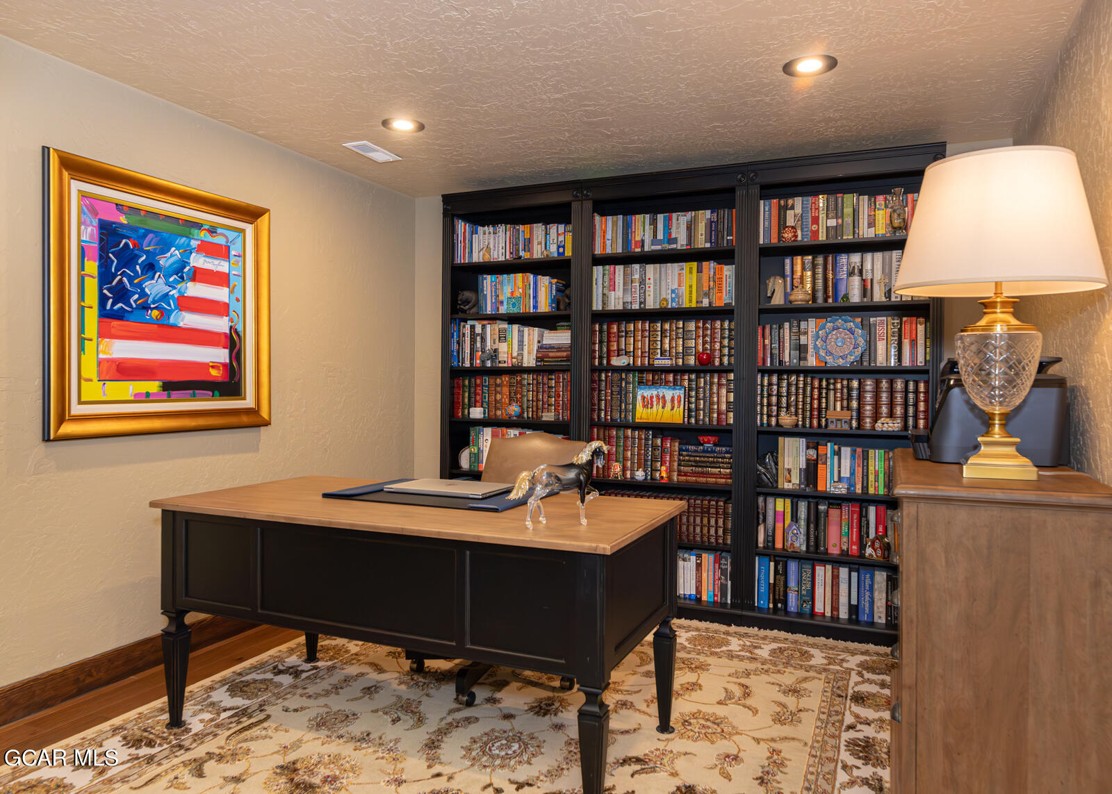 40 Golf Course Circle Tabernash, CO 80478 - Photo 21 of 57 a room with a bookshelf and a table
