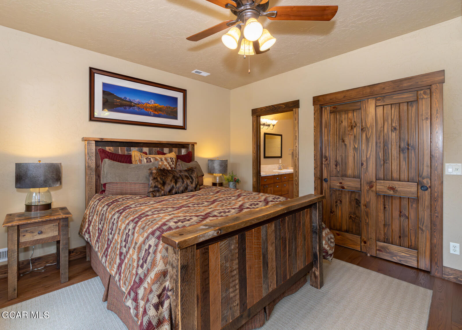40 Golf Course Circle Tabernash, CO 80478 - Photo 25 of 57 a bedroom with a bed and a chandelier