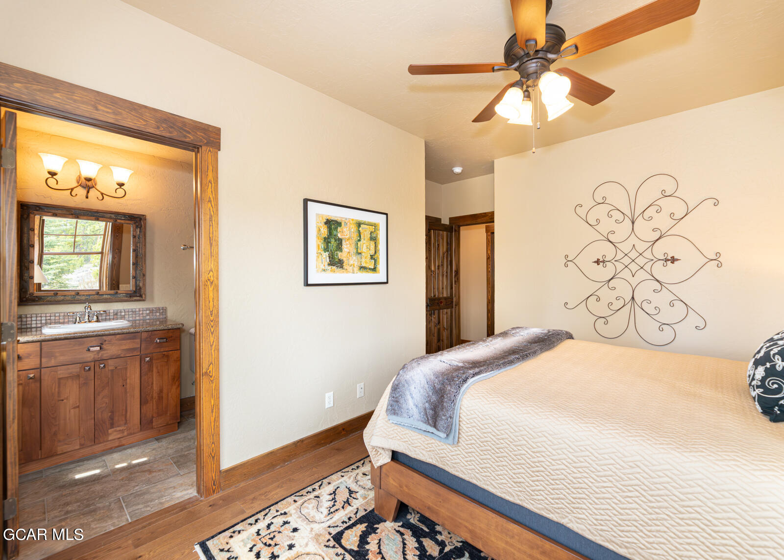 40 Golf Course Circle Tabernash, CO 80478 - Photo 32 of 57 a bedroom with a large bed and a chandelier