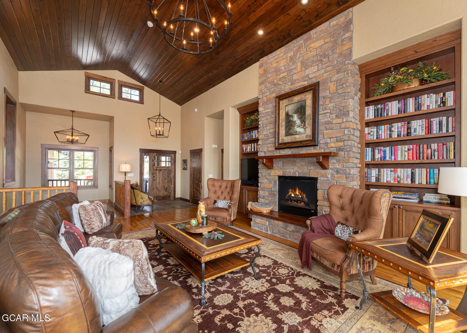 40 Golf Course Circle Tabernash, CO 80478 - Photo 4 of 57 a living room with furniture a chandelier and a fireplace