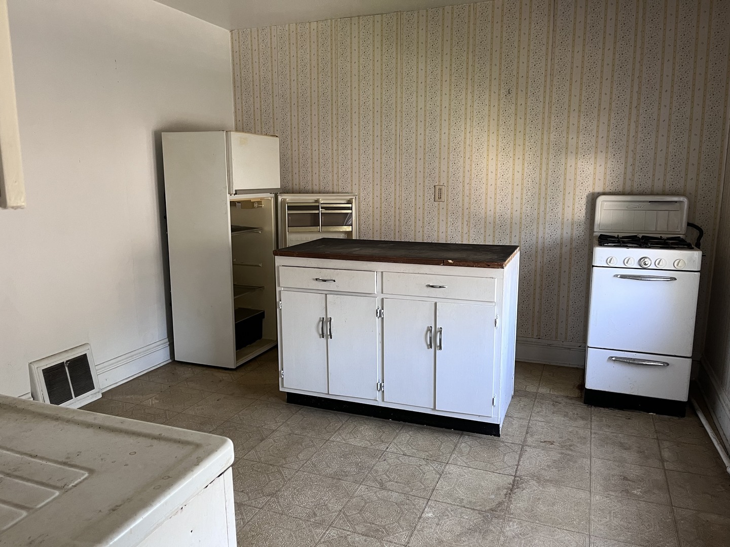 504 Scribner Street Joliet, IL 60432 - Photo 3 of 6 a kitchen with granite countertop white cabinets and refrigerator
