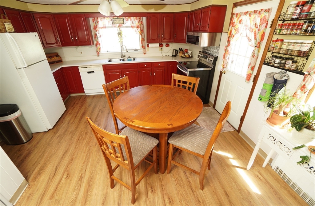 25 A Street Warren, MA 01092 - Photo 11 of 36 a kitchen with stainless steel appliances granite countertop a refrigerator and a stove top oven