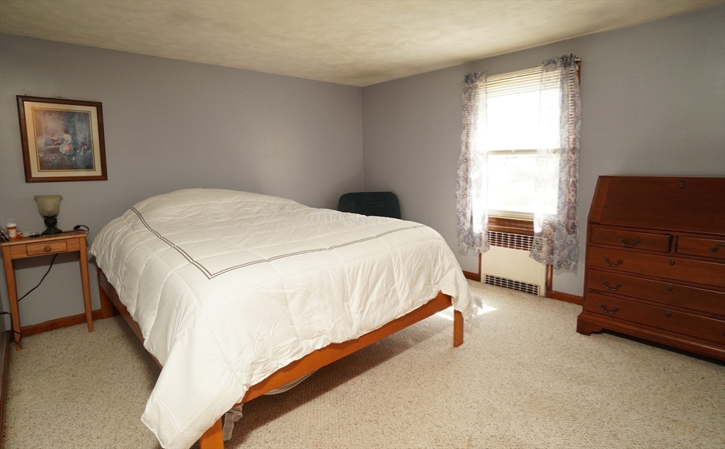 25 A Street Warren, MA 01092 - Photo 18 of 36 a bedroom with a bed and furniture