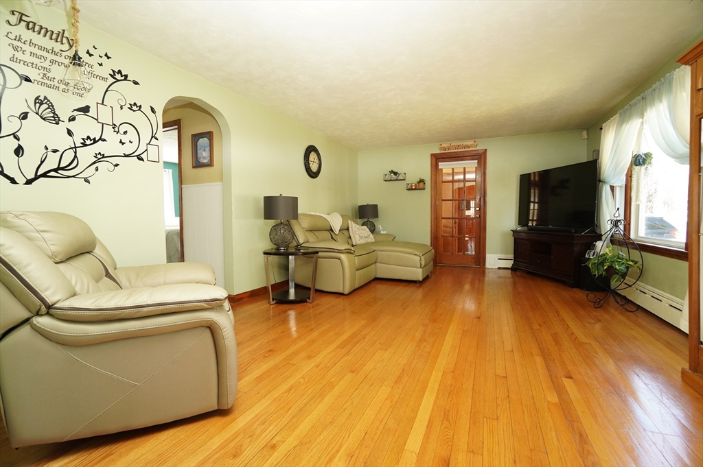 25 A Street Warren, MA 01092 - Photo 4 of 36 a living room with furniture and a flat screen tv