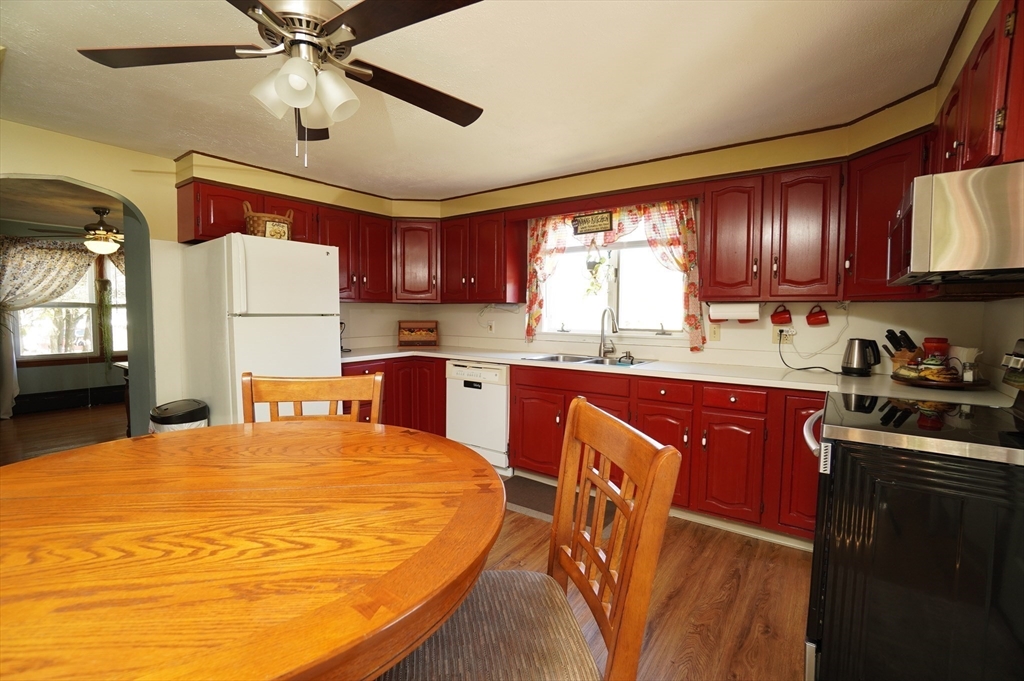 25 A Street Warren, MA 01092 - Photo 9 of 36 a kitchen with stainless steel appliances granite countertop a sink a stove a refrigerator cabinets and a dining table