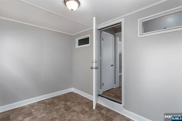 a bedroom with a bed table and window