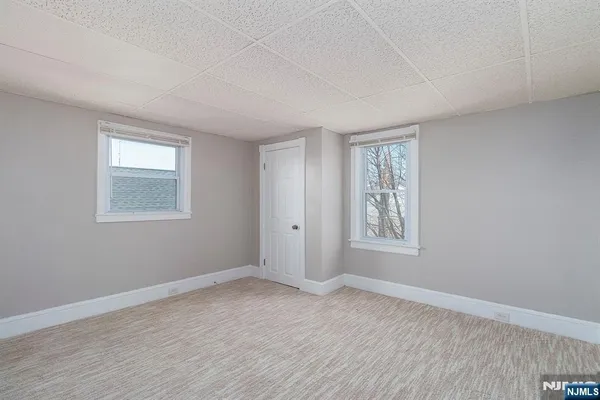 a bedroom with bed and a flat screen tv