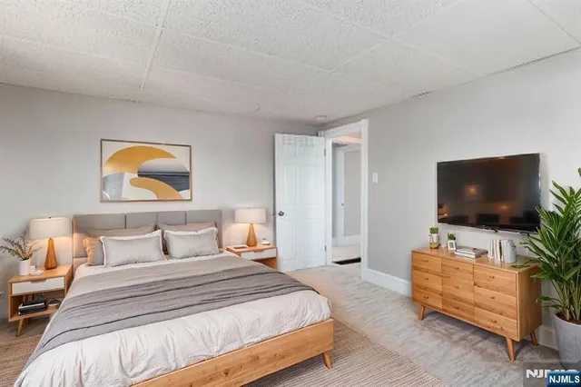 a bedroom with a bed and a painting on the wall