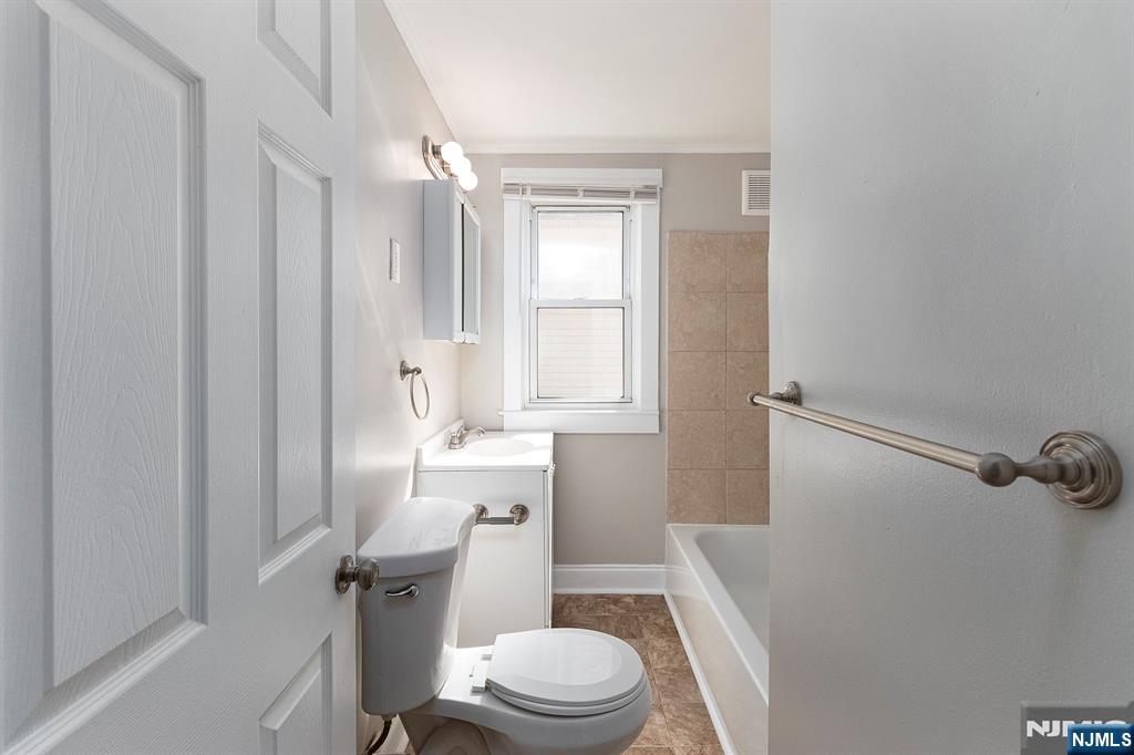 2557 Wh Mer Road Hamilton, NJ 08619 - Photo 23 of 36 a bathroom with a sink a toilet a mirror and shower