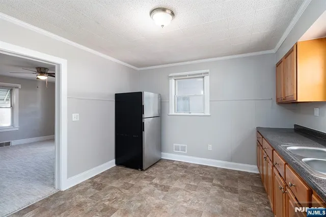 an empty room with window and wooden floor
