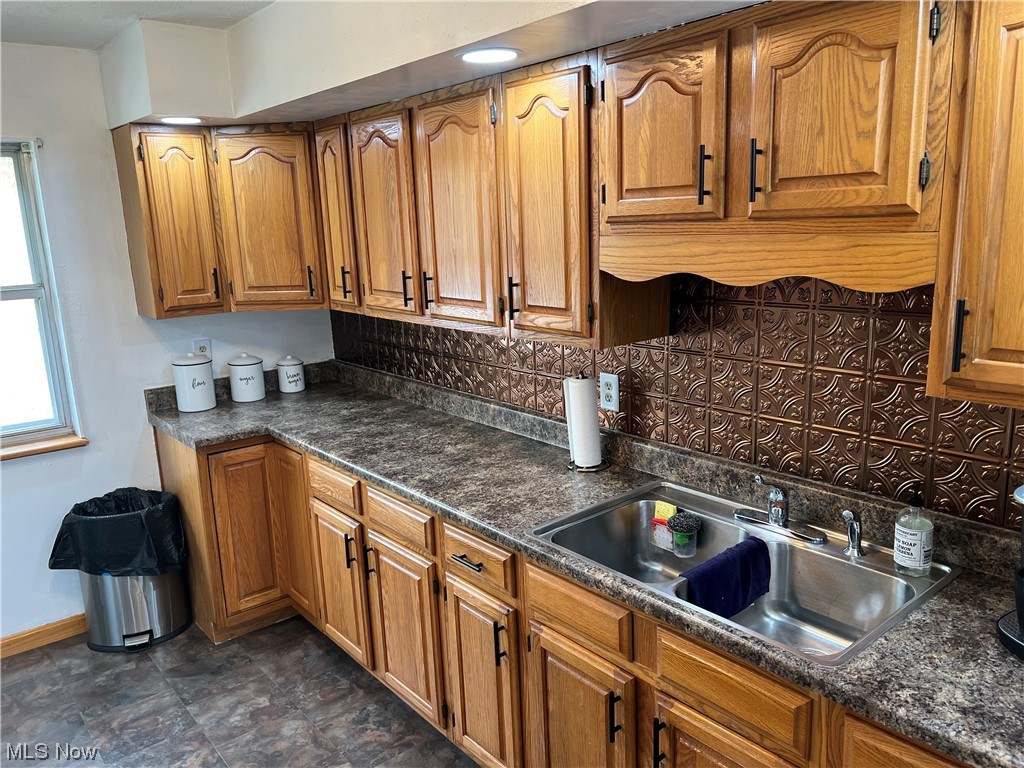 6950 Walker Road Walker, WV 26180 - Photo 5 of 22 Kitchen featuring dark tile flooring, sink, and backsplash