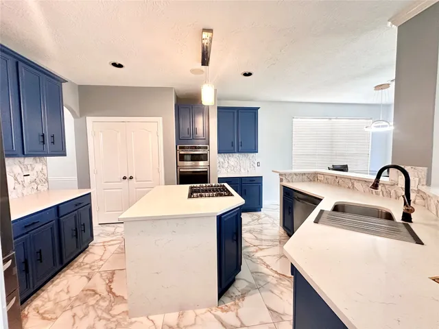 a kitchen that has a sink and a stove in it