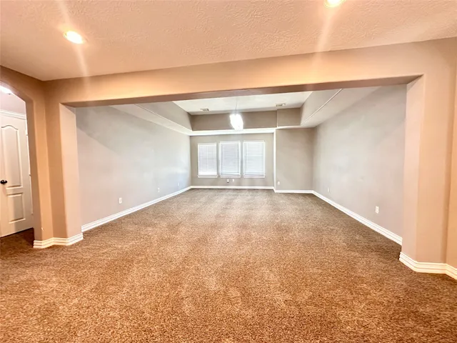 an empty room with a empty space and windows