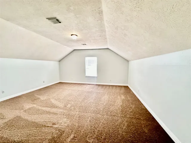 an empty room with a rug