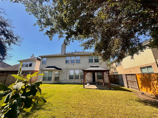 a house view with swimming pool in front of it