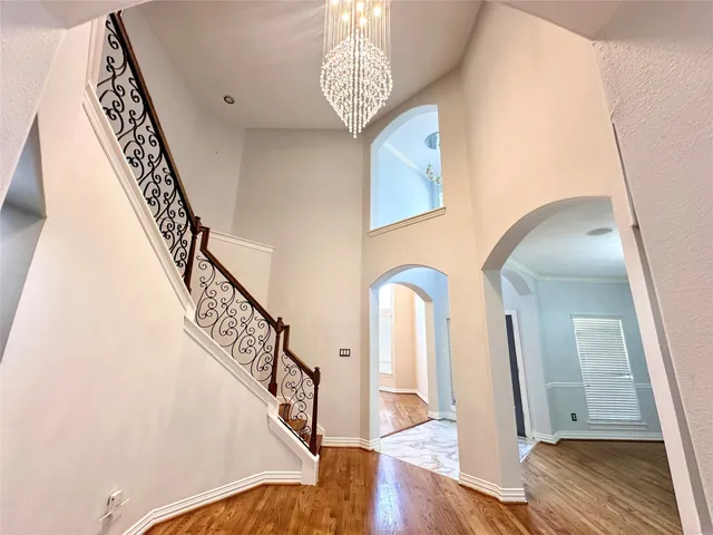 a view of entryway and hall with wooden floor