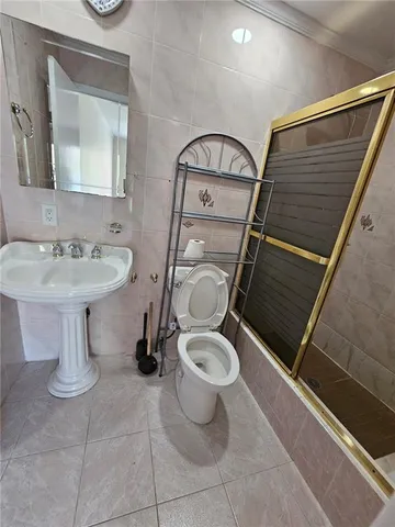 a bathroom with a toilet sink and mirror