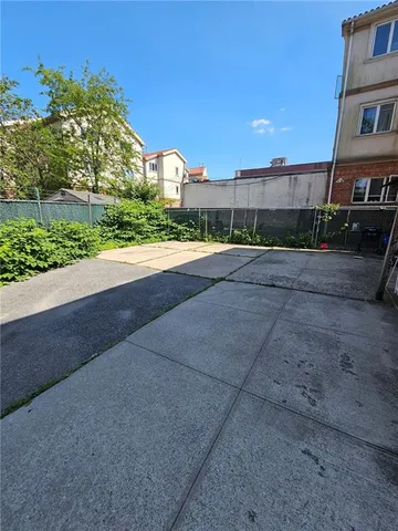 a view of a house with a yard and potted plants
