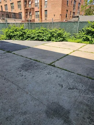 a view of a garden with a building in the background