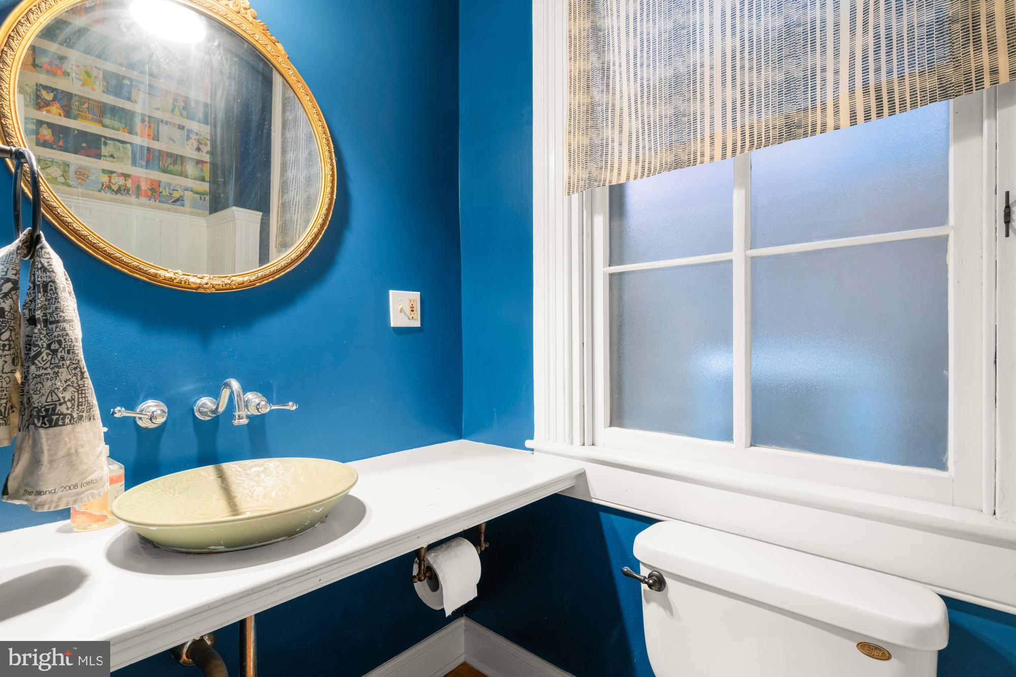 1206 John Street Baltimore, MD 21201 - Photo 17 of 53 a bathroom with a sink and a mirror