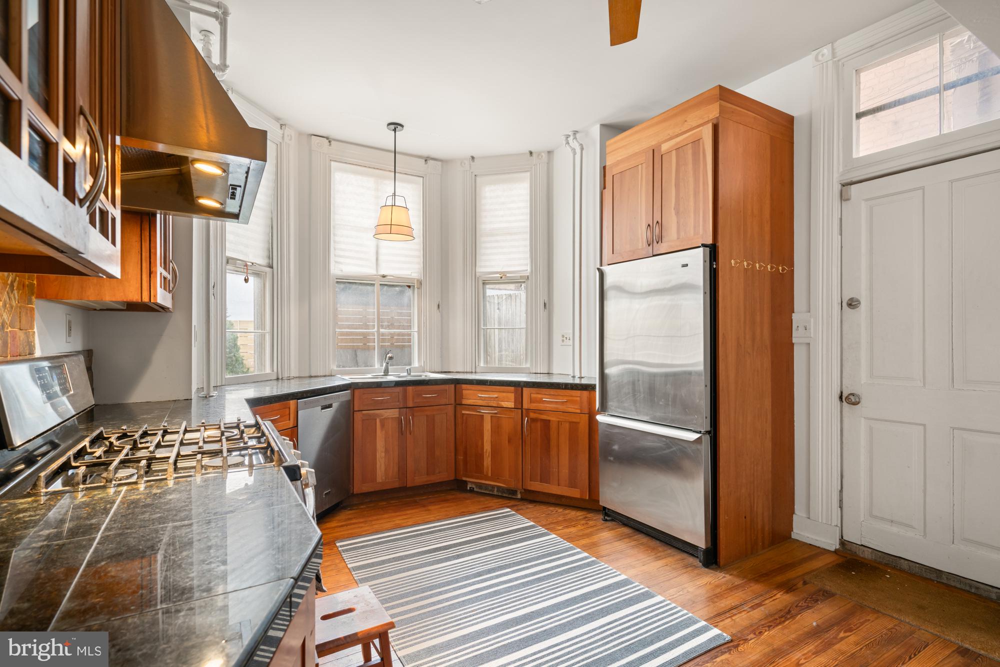 1206 John Street Baltimore, MD 21201 - Photo 18 of 53 a bedroom with a bed and wooden floor