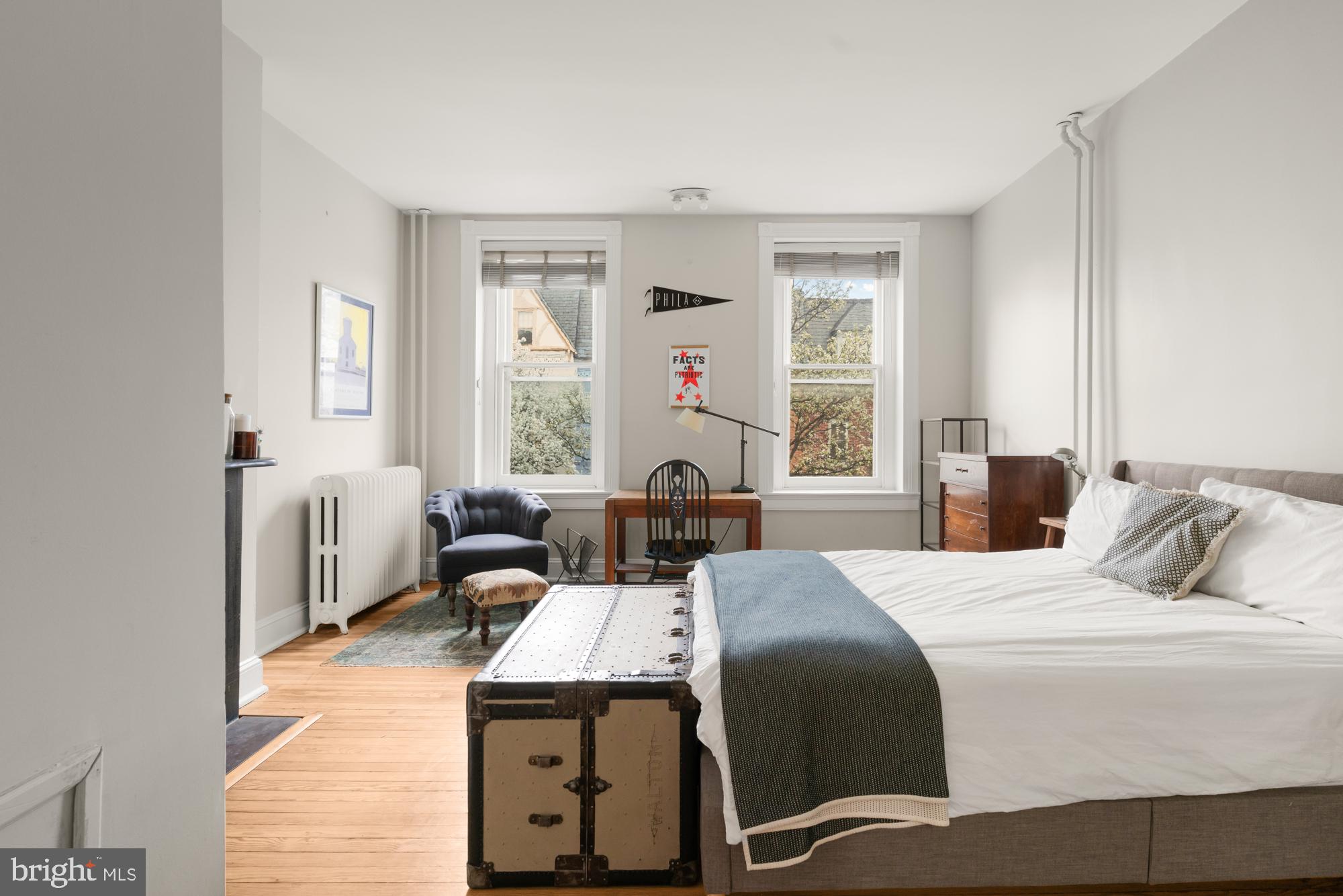 1206 John Street Baltimore, MD 21201 - Photo 24 of 53 a bedroom with a bed and a chandelier