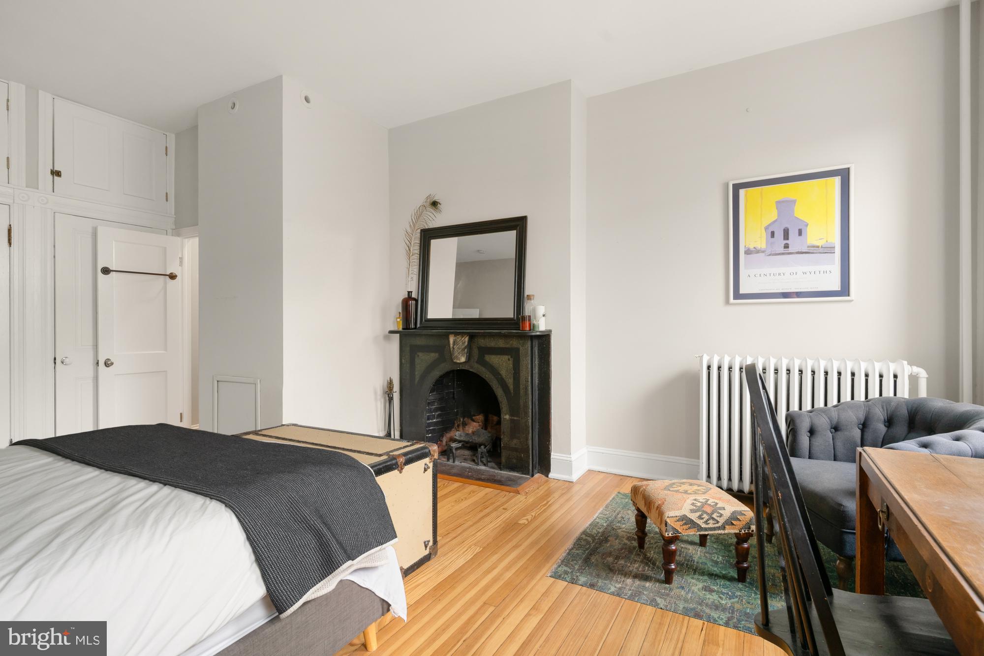 1206 John Street Baltimore, MD 21201 - Photo 25 of 53 a bedroom with a bed and a fireplace