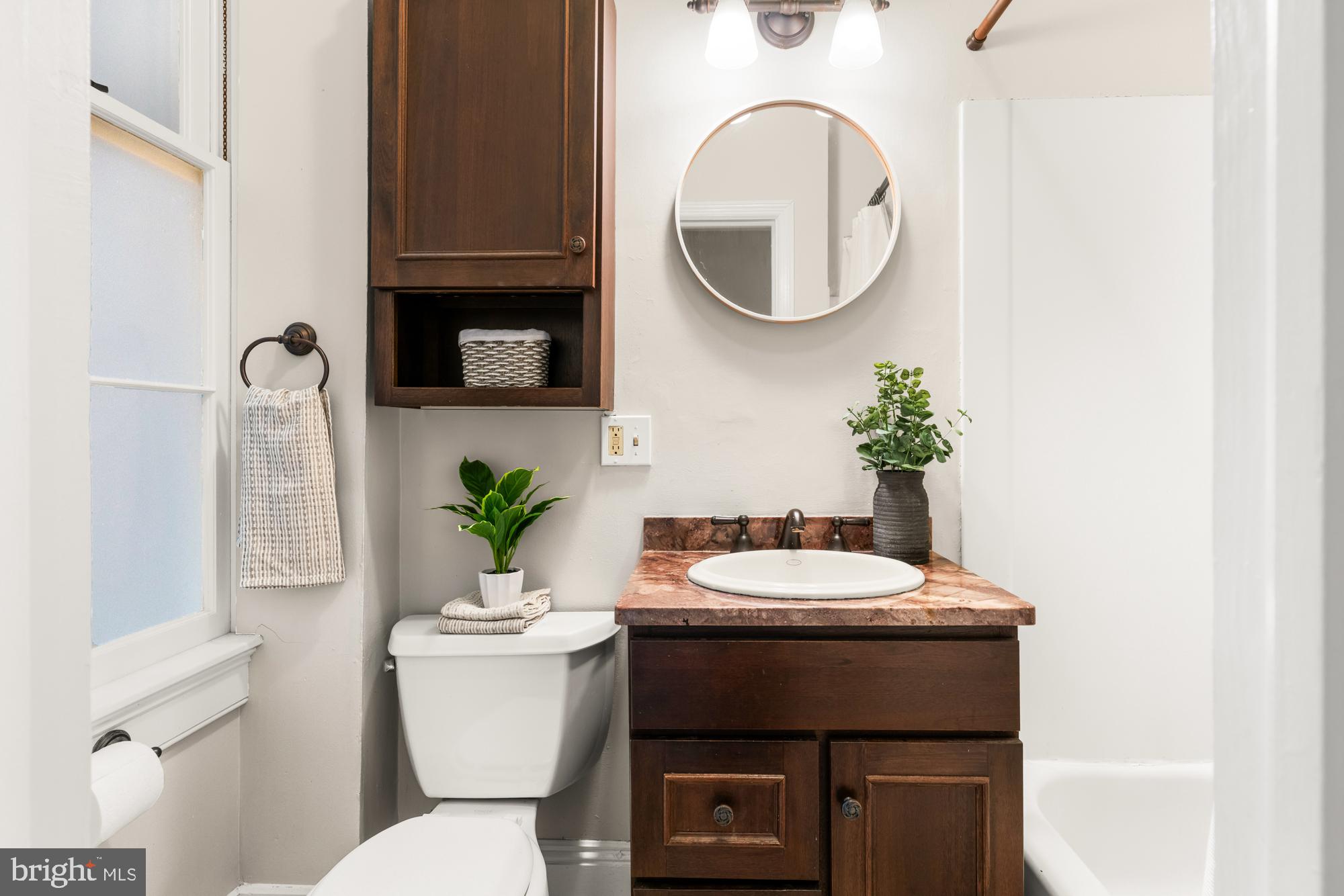 1206 John Street Baltimore, MD 21201 - Photo 27 of 53 a bathroom with a toilet a sink and a mirror