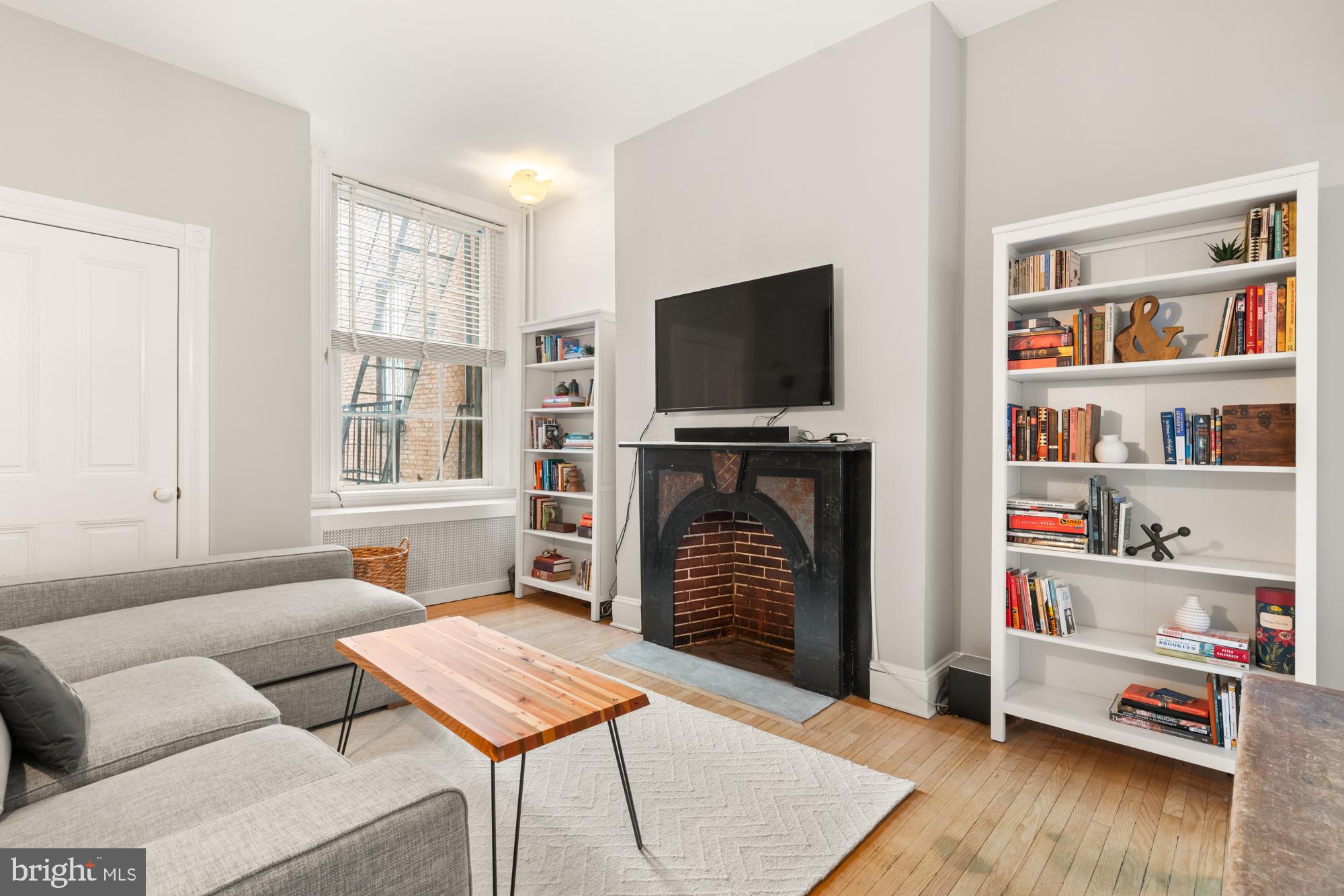 1206 John Street Baltimore, MD 21201 - Photo 28 of 53 a living room with furniture and a flat screen tv