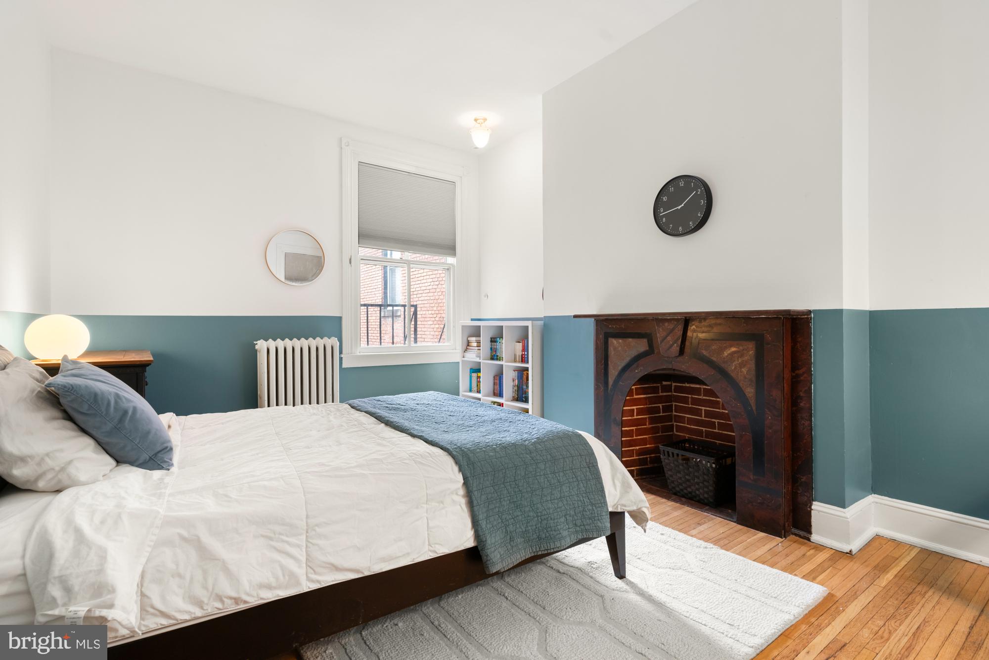 1206 John Street Baltimore, MD 21201 - Photo 39 of 53 a bedroom with a bed and a fireplace