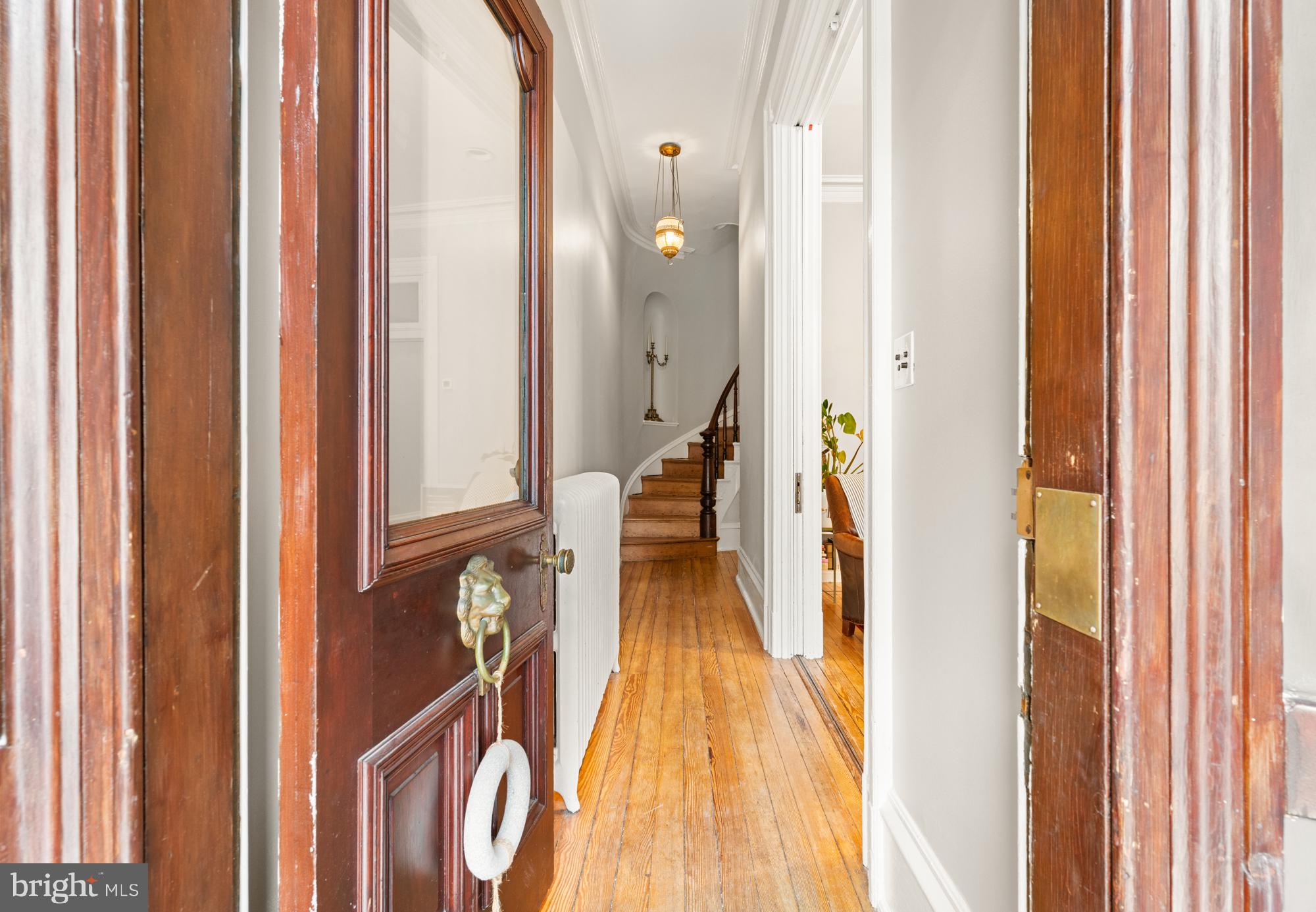 1206 John Street Baltimore, MD 21201 - Photo 4 of 53 a view of a hallway with wooden floor and staircase