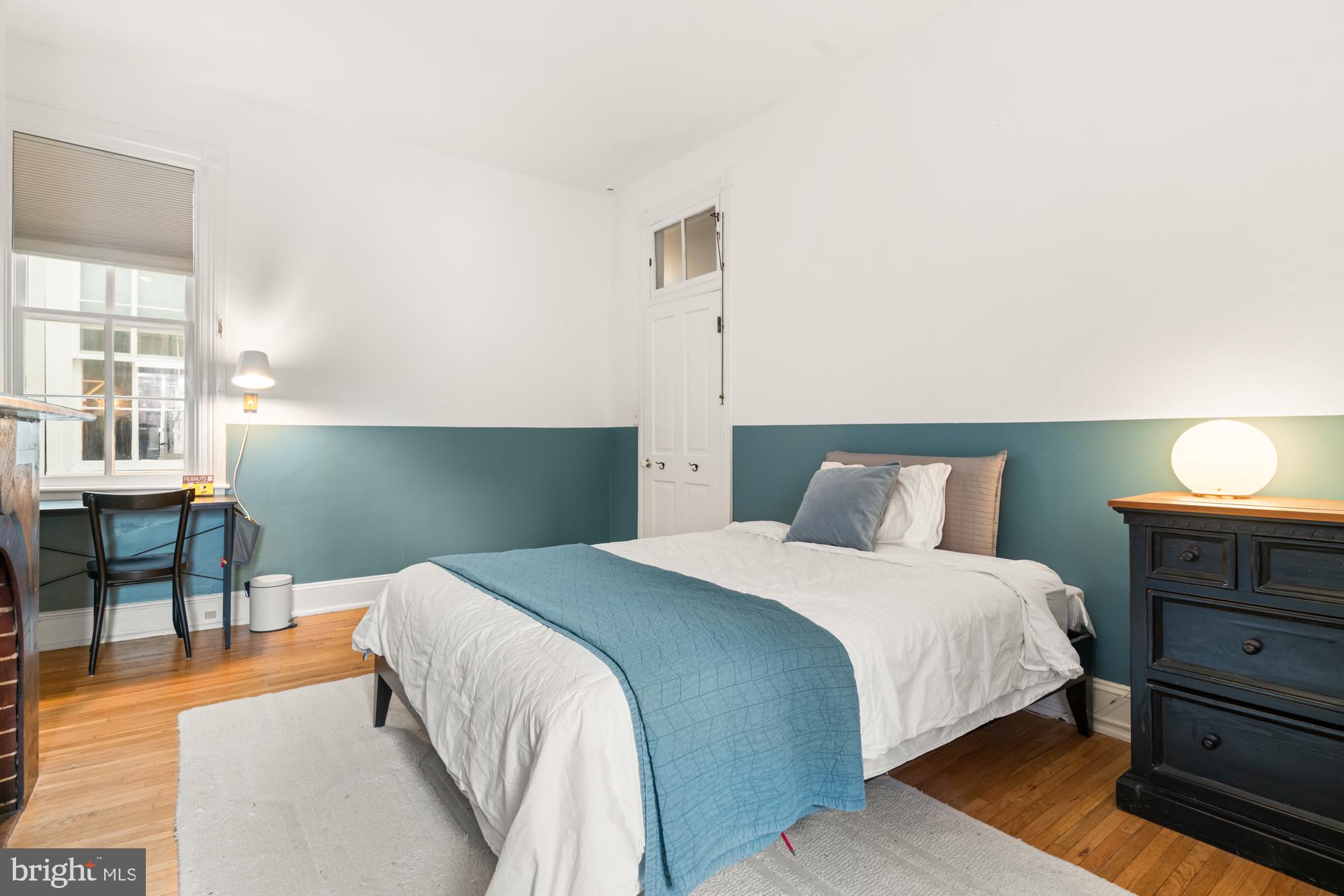 1206 John Street Baltimore, MD 21201 - Photo 41 of 53 a bedroom with a bed and a table