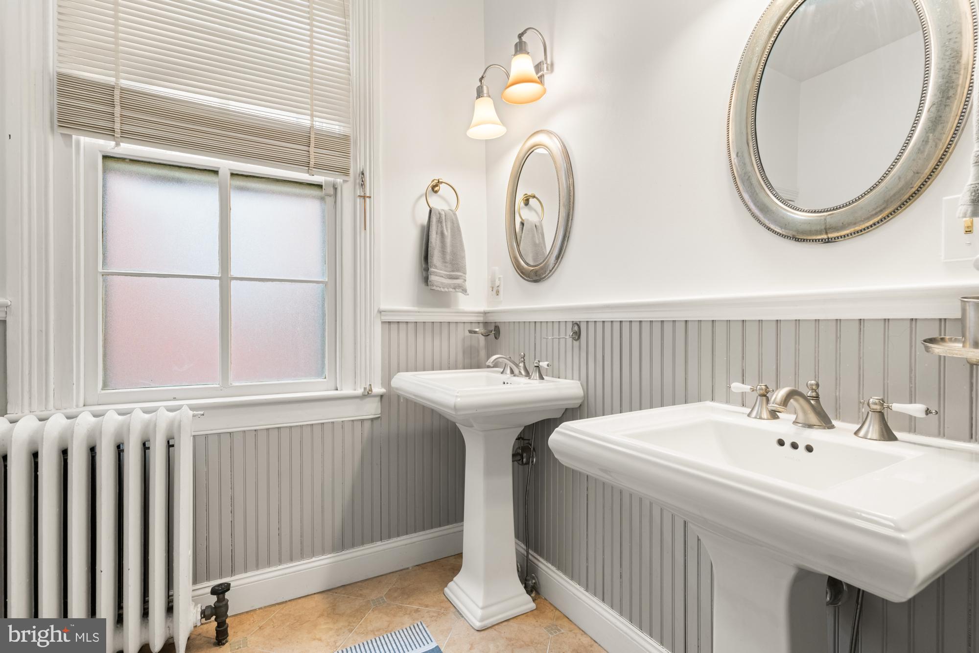 1206 John Street Baltimore, MD 21201 - Photo 43 of 53 a bathroom with a sink and a mirror