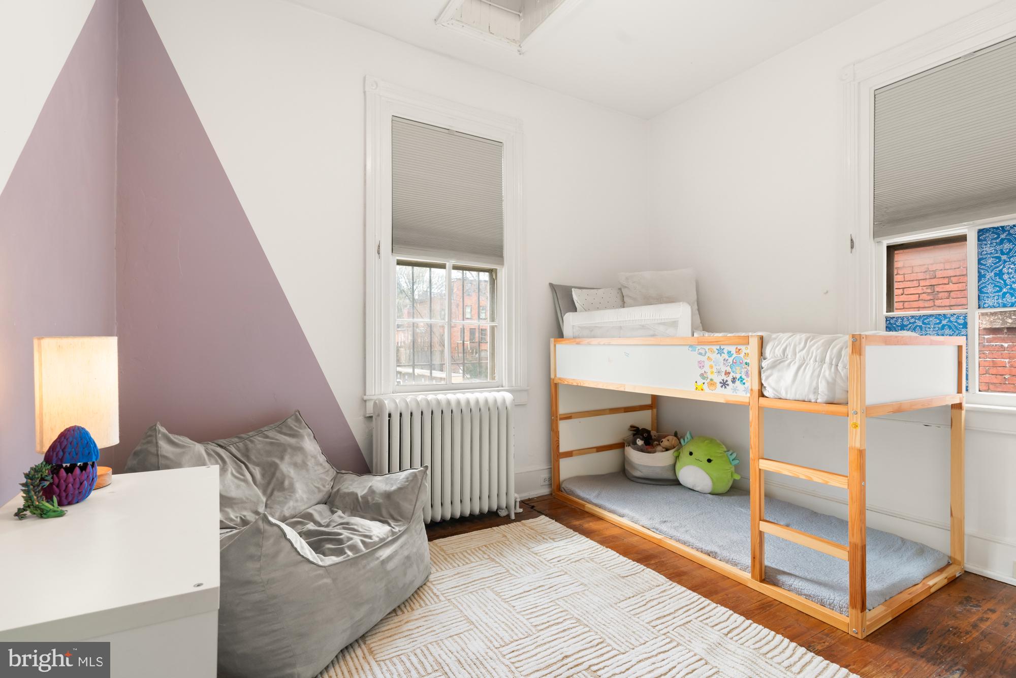 1206 John Street Baltimore, MD 21201 - Photo 44 of 53 a bedroom with a bed and a window