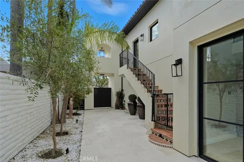 a living room with furniture a fireplace and a potted plant