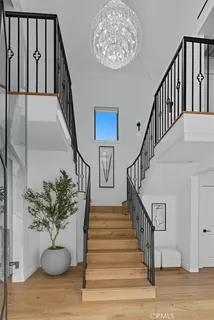 a living room with furniture a chandelier and a large window