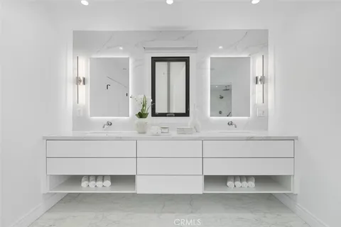 a bathroom with a sink vanity and mirror