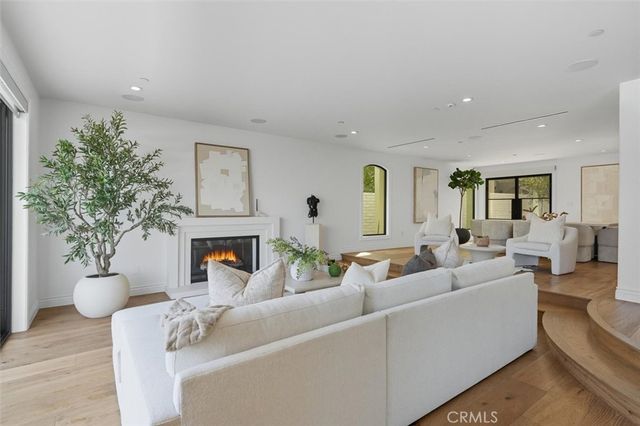 a kitchen with stainless steel appliances kitchen island granite countertop a sink a stove a refrigerator and cabinets