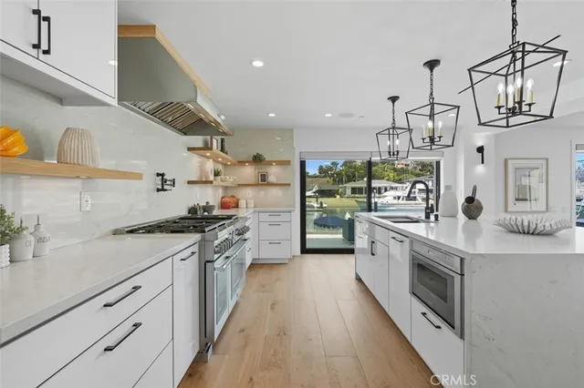 a kitchen with white cabinets and appliances