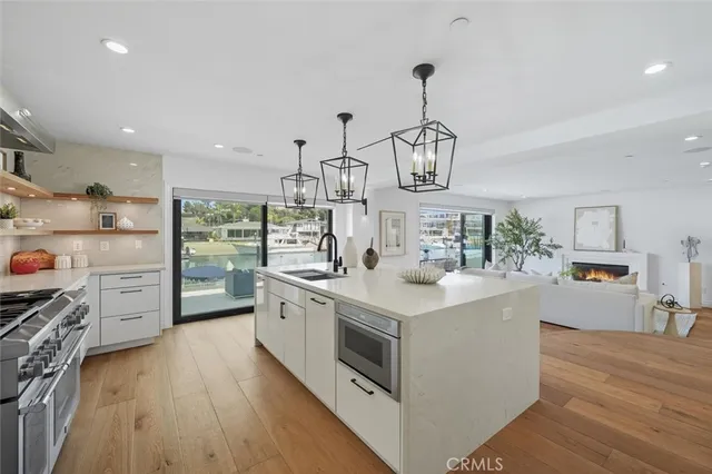 a kitchen with granite countertop white cabinets stainless steel appliances and a sink