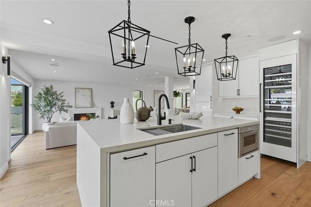 a living room with kitchen island furniture and a potted plant