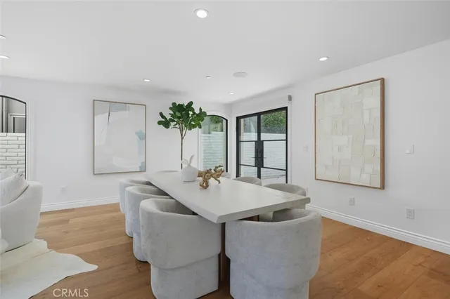a living room with furniture potted plant and a chandelier